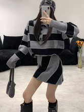 A lady's color-blocking striped polo collar top paired with a skirt suit